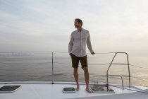 Marure man on catamaran, looking ta view — Stock Photo