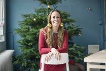 Portrait laughing woman wearing golden Christmas bauble earrings — Stock Photo
