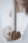 Donna che pratica Wushu e bilanciamento bastone di legno sulla punta delle dita, primo piano — Foto stock