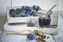 Conservazione di vasetto di confettura di prugne, prugne e ingredienti su legno — Foto stock