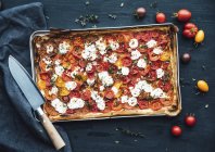 Tomato tart with goat cheese and thyme on mustard — Stock Photo
