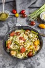 Spaghetti with shrimps, green asparagus, tomatoes, pesto and parmesan — Stock Photo