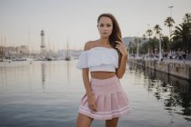 Fashionable young woman posing at harbour of Barcelona, Spain — Stock Photo