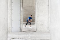 Man stetching at an underpass — Stock Photo