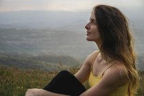 Spain, Barcelona, portrait of young woman relaxing on Montcau Mountain — Stock Photo
