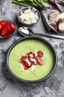 Green asparagus cream soup with strawberries, parmesan and baguette — Stock Photo