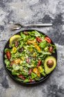 Salad with lamb's lettuce, tomatoes, avocado, parmesan and curcuma lemon dressing — Stock Photo