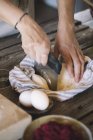 Raw pasta dough in kitchen towel, dough scraper — Stock Photo