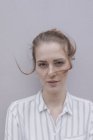 Портрет красивой женщины с выветренными волосами на сером фоне — стоковое фото