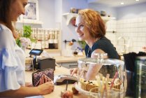Client payant par carte de crédit dans un café — Photo de stock