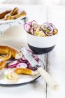 Obatzda with red onion, radish, spring onion and pretzel — Stock Photo