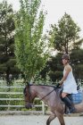 Happy woman riding on horse in nature — Stock Photo