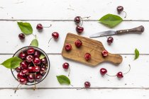 Sliced and whole cherries — Stock Photo
