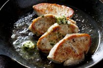 Fillet of turkey with herb butter in pan — Stock Photo