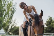 Portrait of happy woman riding on horse outdoors — Stock Photo