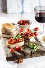 Italian buschetta and glass of red wine — Stock Photo