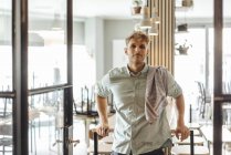 Young man working in start-up cafe, portrait — Stock Photo
