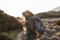 Italy, Sardinia, portrait of bearded hiker with hat and backpack — Stock Photo