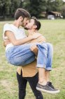 Kissing young gay couple in park — Stock Photo