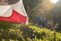 Österreich, Tirol, Wanderer macht Pause, sitzt auf Gras im Zelt — Stockfoto