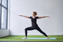 Woman doing yoga exercise in studio — Stock Photo
