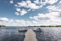 Finland, Jetty with boats in a remote lake — Stock Photo