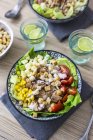 Bowl of Caesar salad with meat, corn and tomatoes — Stock Photo