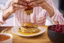 Young woman having sweet pancakes for breakfast, close up — Stock Photo