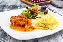 Tuscan pork fillet with tagliatelle and salad — Stock Photo