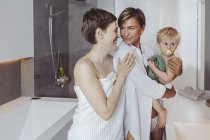Happy lesbian couple and their little son in the bathroom — Stock Photo