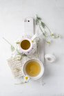Chamomile tea in pot and cup — Stock Photo
