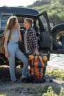 Young couple doing outdoor trip, hiking with backpacks — стокове фото