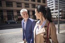 Smiling mature couple walking in city — Stock Photo