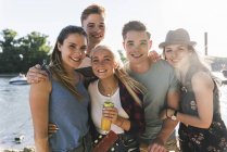 Portrait of group of happy friends at the riverside — Stock Photo