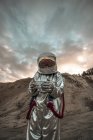 Spaceman exploring nameless planet, holding analyzer — Stock Photo