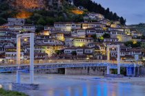 Albania, Berat County, Berat, Mangalem, Ottoman houses and castle rock at blue hour, bridge over Osum river — Stock Photo
