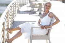 Senior woman relaxing on bench — Stock Photo