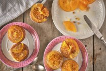 Preparing muffins with candied orange slices — Stock Photo