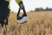 Close-up of man in protective workwear and VR glasses in a field — Stock Photo