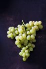 Green grapes on dark metal — Stock Photo