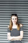 Portrait of young woman wearing striped dress — Stock Photo