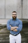 Portrait of bearded hipster businessman wearing glasses and plaid shirt — Stock Photo