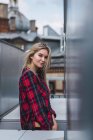 Portrait of smiling blond young woman wearing plaid shirt — Stock Photo