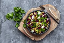Bowl of beetroot salad with avocado, feta, walnuts and parsley — Stock Photo