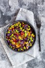 Salad with edamame, maize, red cabbage, carrot, bulgur, tomato, from above — Stock Photo
