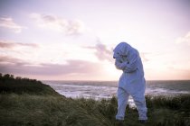 Denmark, Nordjuetland, Man wearing ice bear costume at the beach — Stock Photo
