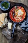 Eggs in Purgatory, eggs, baked in very spicy tomato sauce, sprinkled with parsley and parmegiano — Stock Photo
