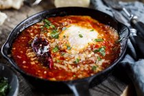 Eggs in Purgatory, eggs, baked in very spicy tomato sauce, sprinkled with parsley and parmegiano — Stock Photo