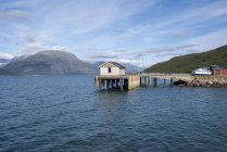 Norway, Skibotn, harbour, wooden hut at lake in mountains — Stock Photo