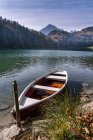 Germany, Bavaria, East Allgaeu, Fuessen, Alatsee, boat at lakeside in autumn — Stock Photo